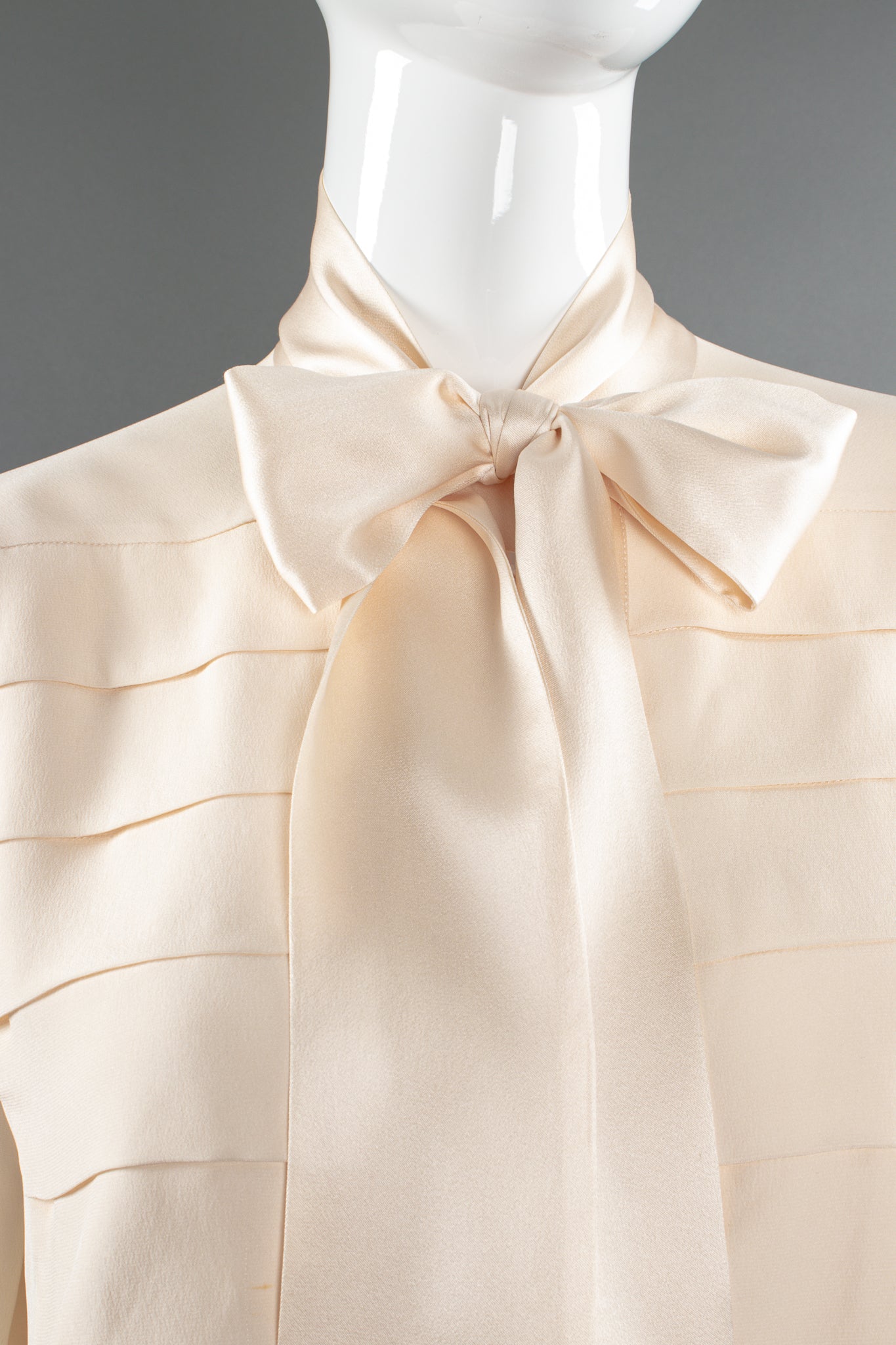 Vintage Chanel Cream Silk Panel Tuck Bow Blouse on Mannequin front crop at Recess Los Angeles