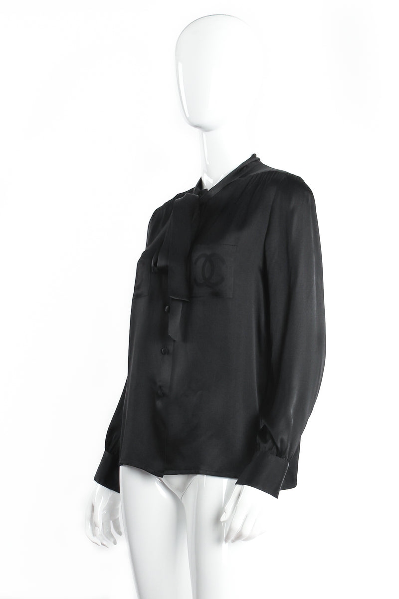 Vintage Chanel CC Pocket Black Silk Tie Neck Blouse on mannequin angle at Recess Los Angeles