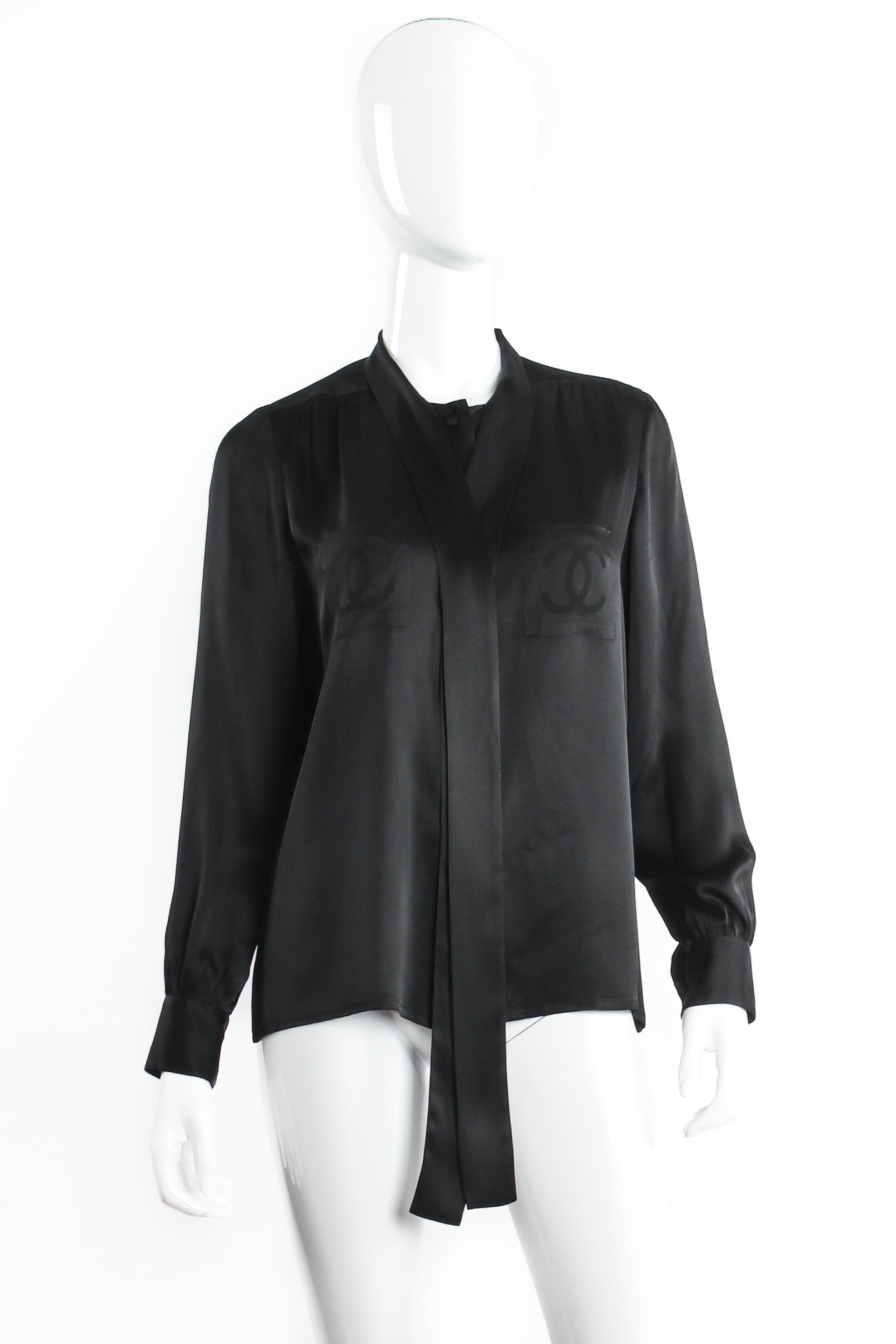 Vintage Chanel CC Pocket Black Silk Tie Neck Blouse on mannequin front untie at Recess Los Angeles