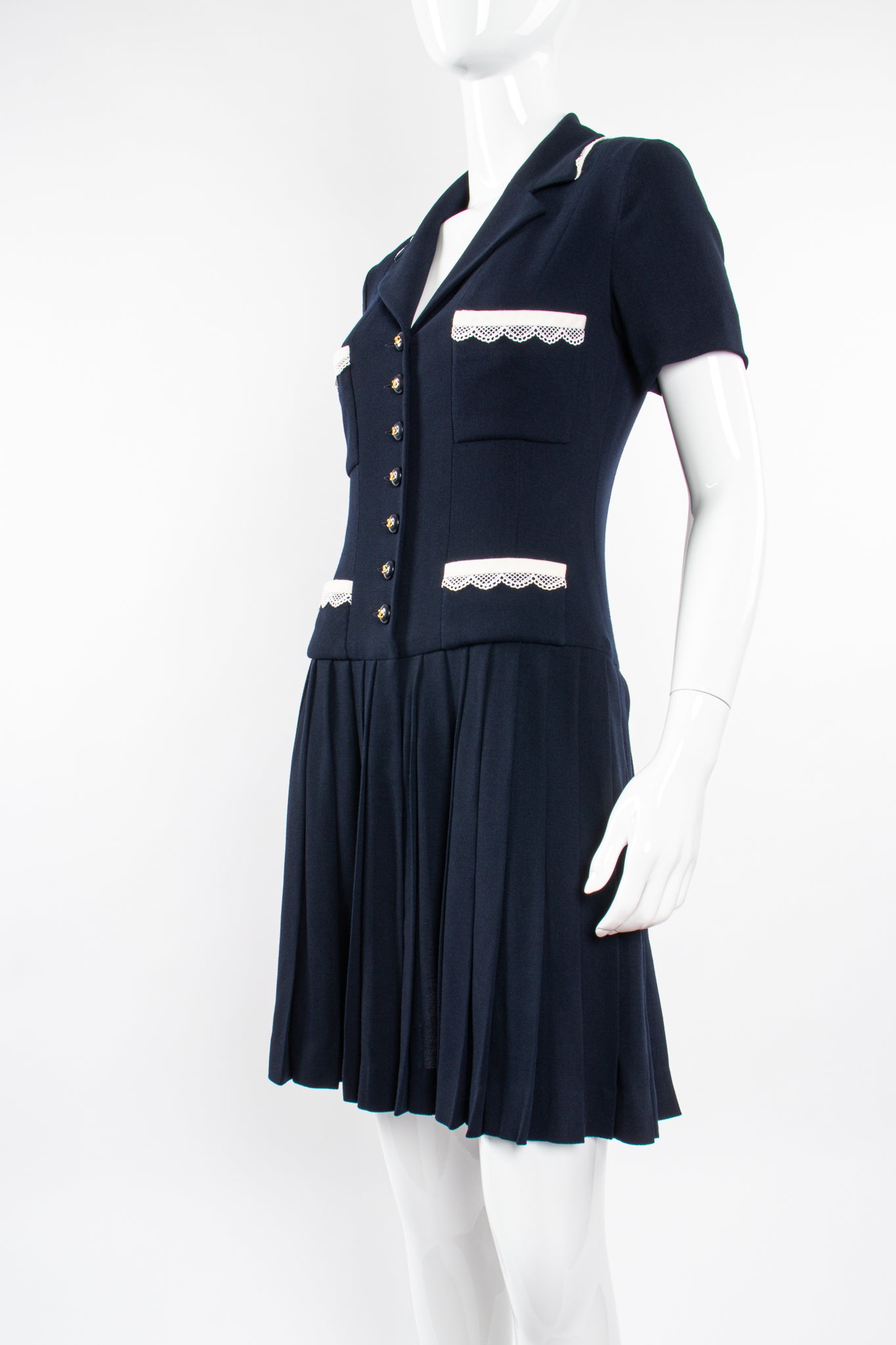 Vintage Chanel 1995C Lace Trim Pleated Uniform Dress on Mannequin front angle at Recess Los Angeles