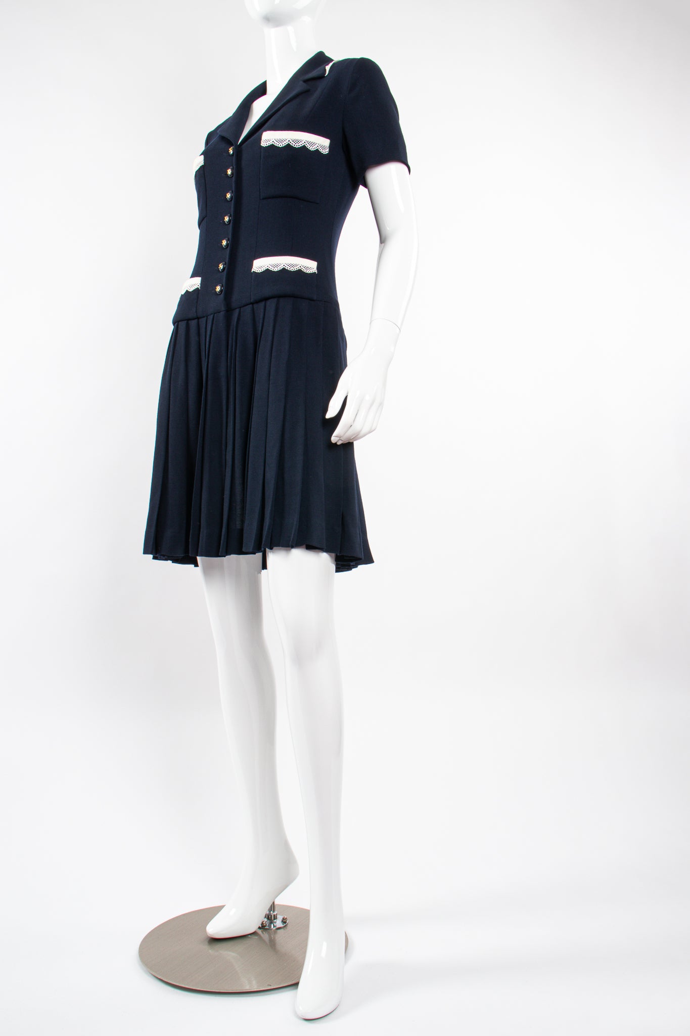 Vintage Chanel 1995C Lace Trim Pleated Uniform Dress on Mannequin front angle at Recess Los Angeles