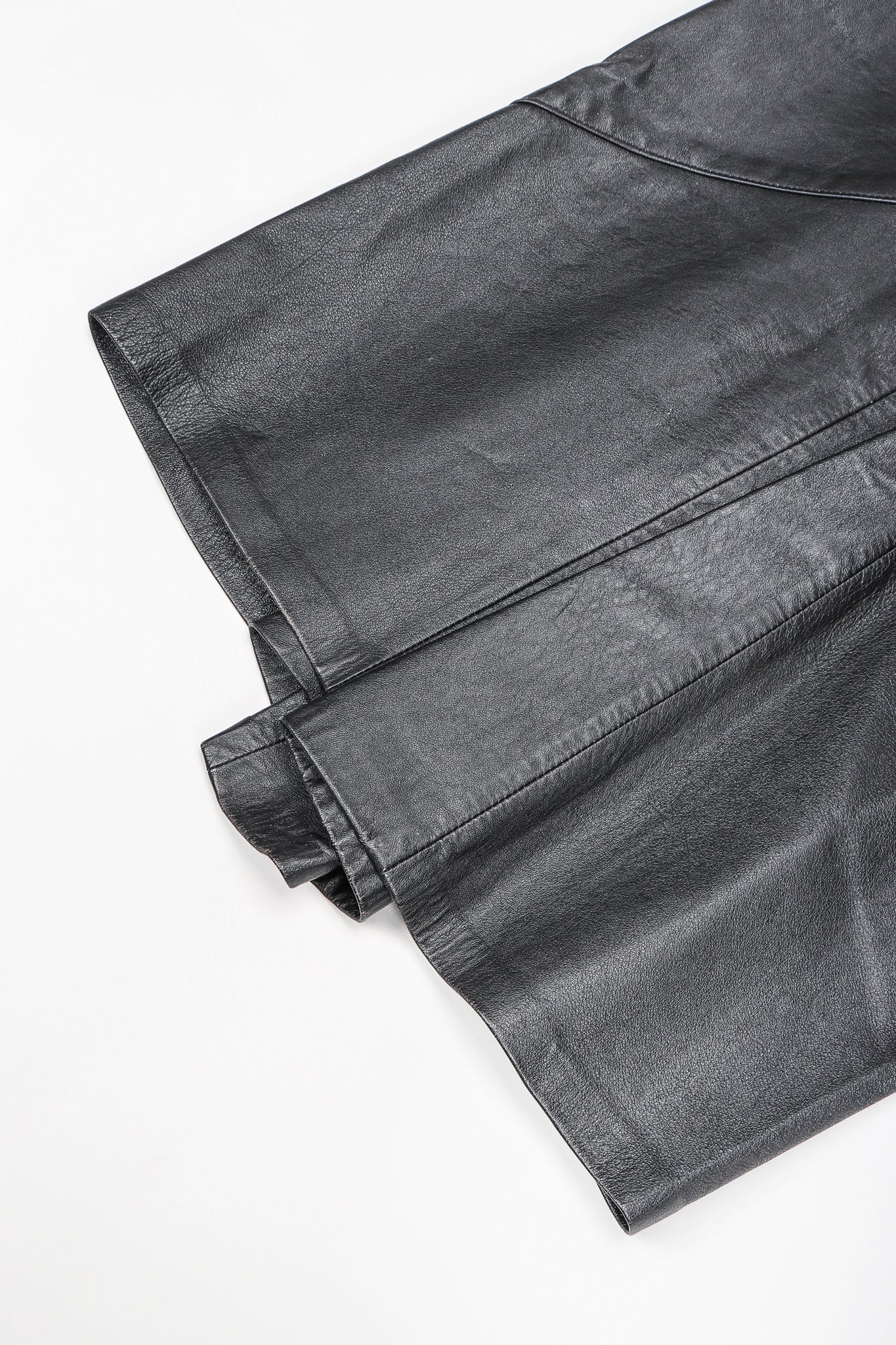 Dero Enterprises Black Leather Skirt, Hem Detail On White Background at Recess Vintage