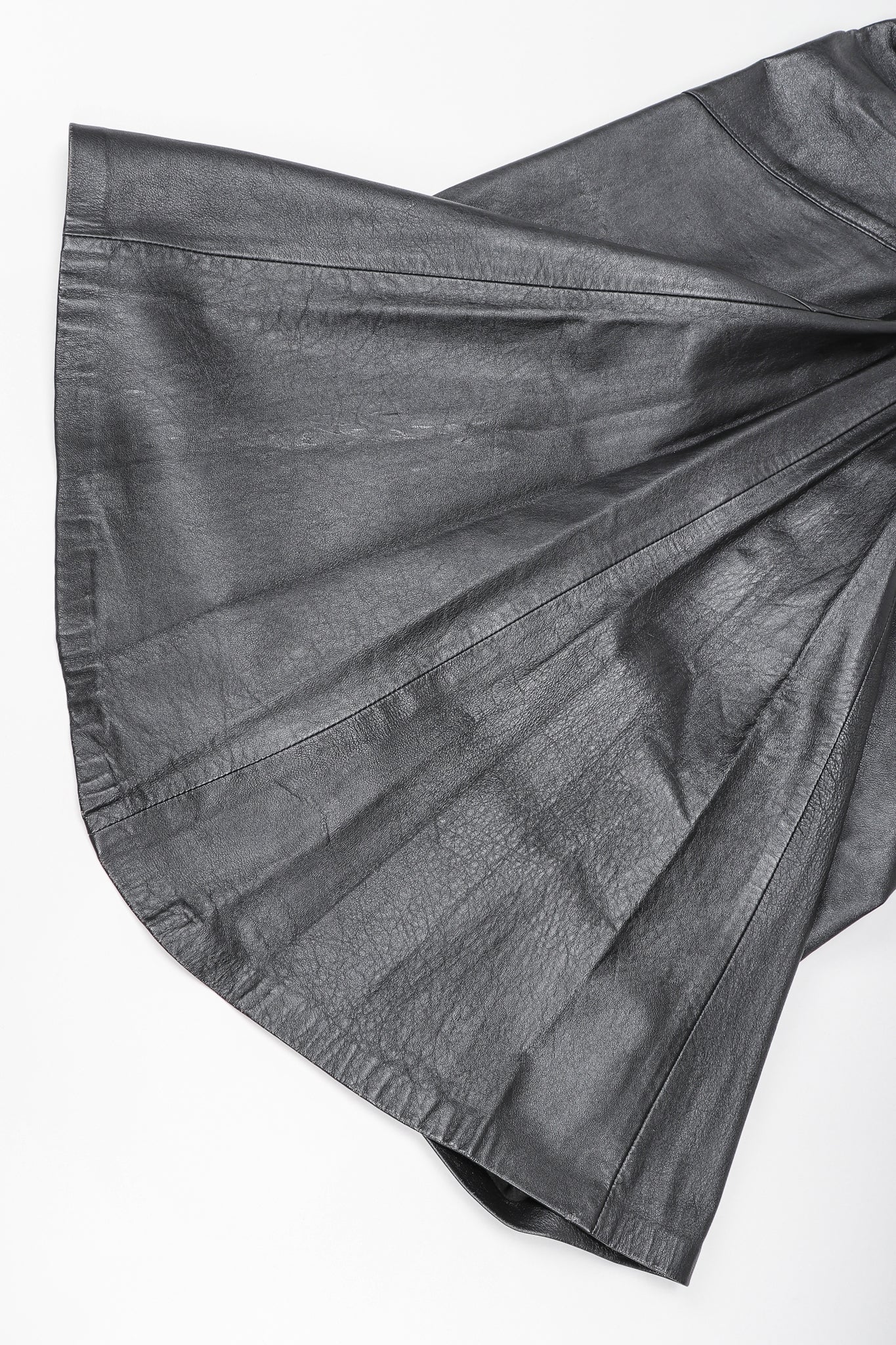 Dero Enterprises Black Leather Skirt, Flare Detail On White Background at Recess Vintage