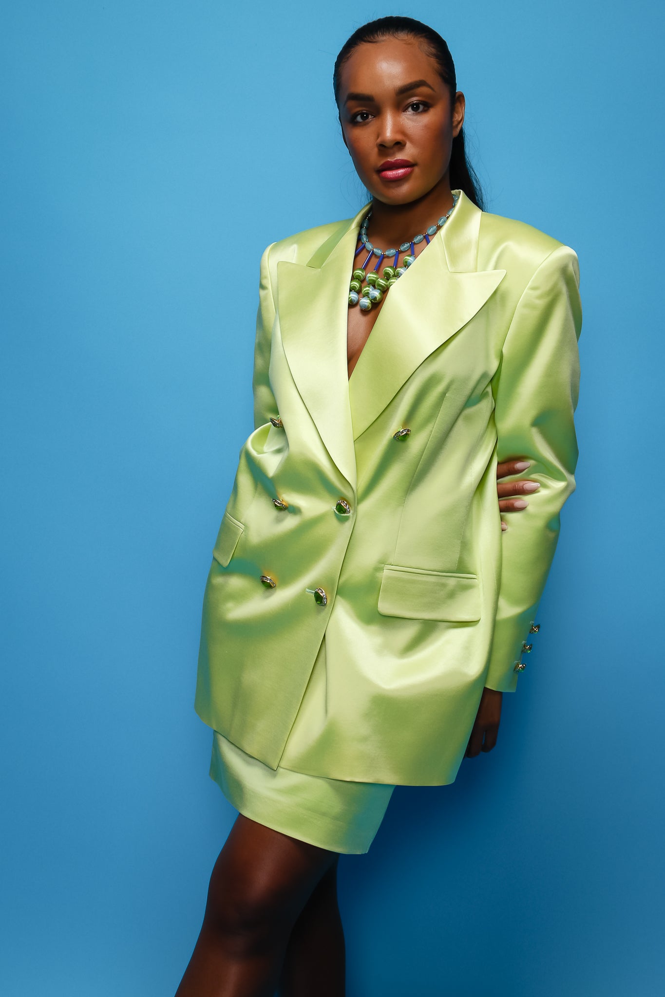 Brittany Hampton in Vintage Escada Satin Double Breasted Skirt Suit on blue at Recess Los Angeles