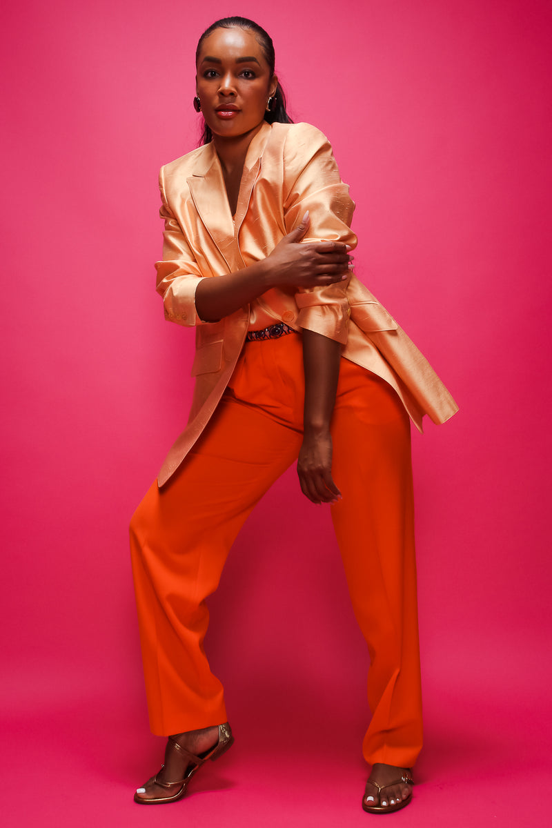 Brittany Hampton in Vintage Escada Orange Double Pleated Pant on pink at Recess Los Angeles