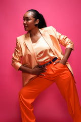 Brittany Hampton in Vintage Escada Orange Double Pleated Pant on pink at Recess Los Angeles