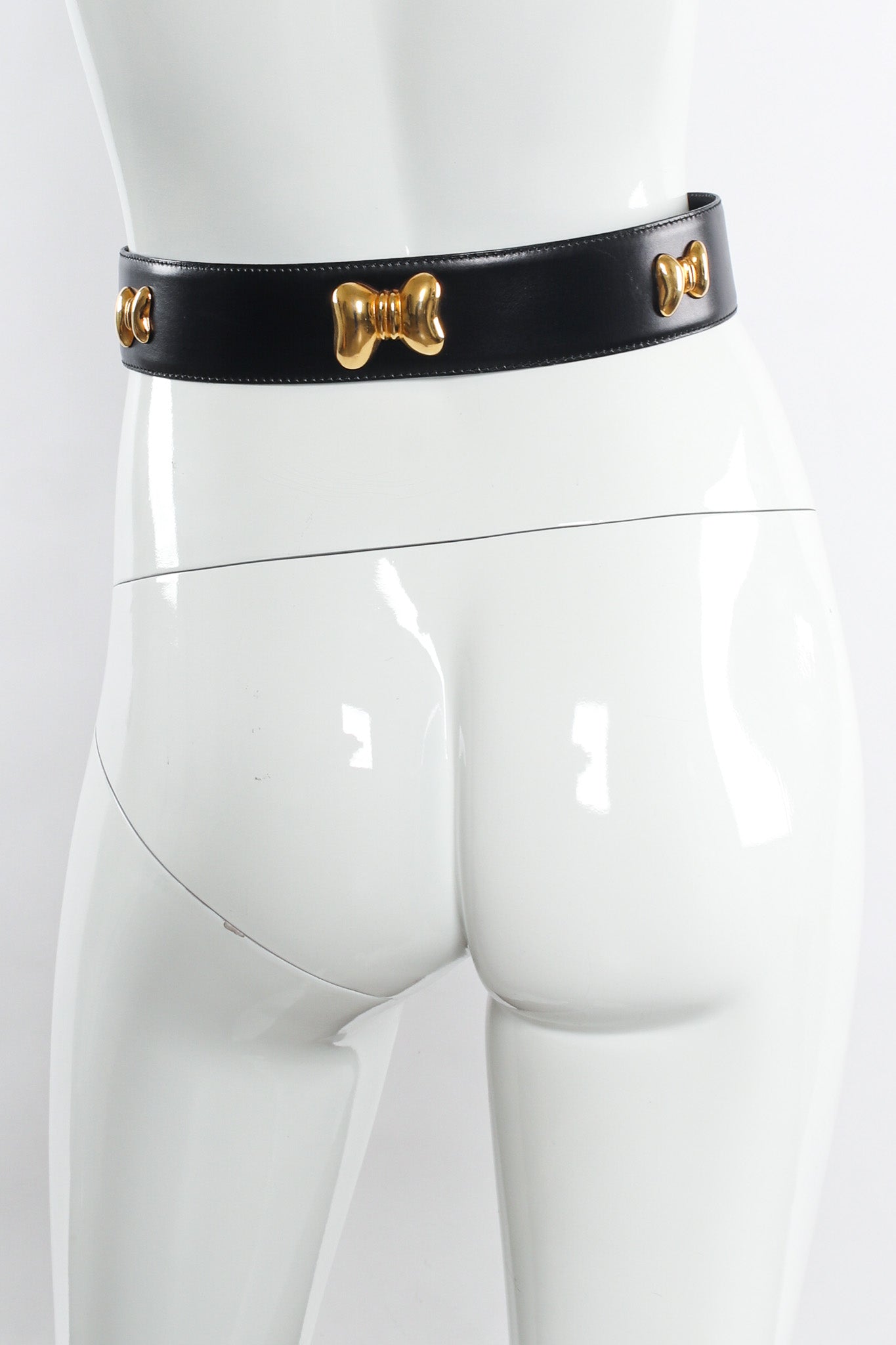Wide black leather belt with gold bow studs by Escada on mannequin back @recessla
