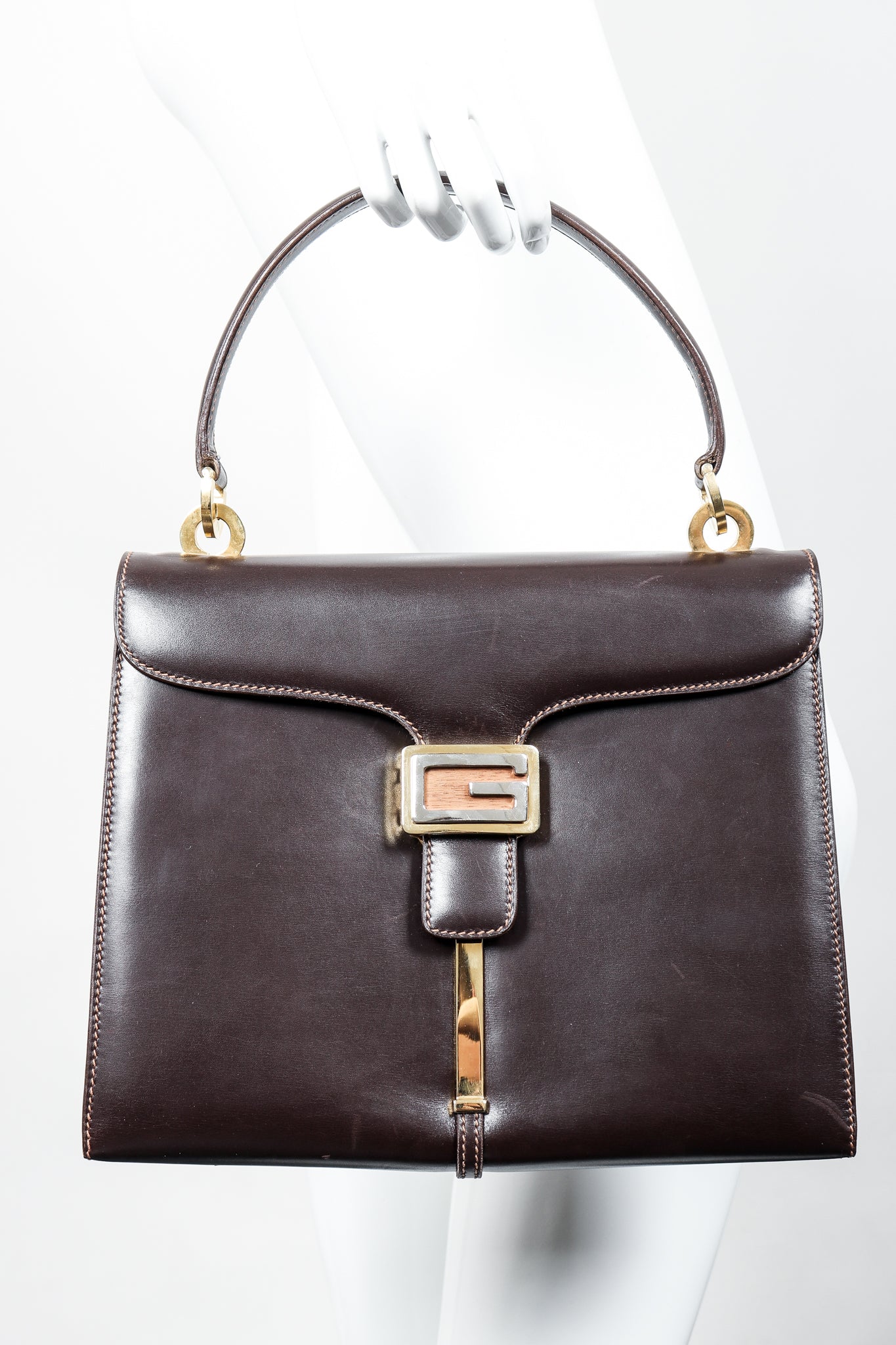 Vintage Gucci 70s Leather Logo G Clasp Satchel Handbag in mannequin hand at Recess Los Angeles