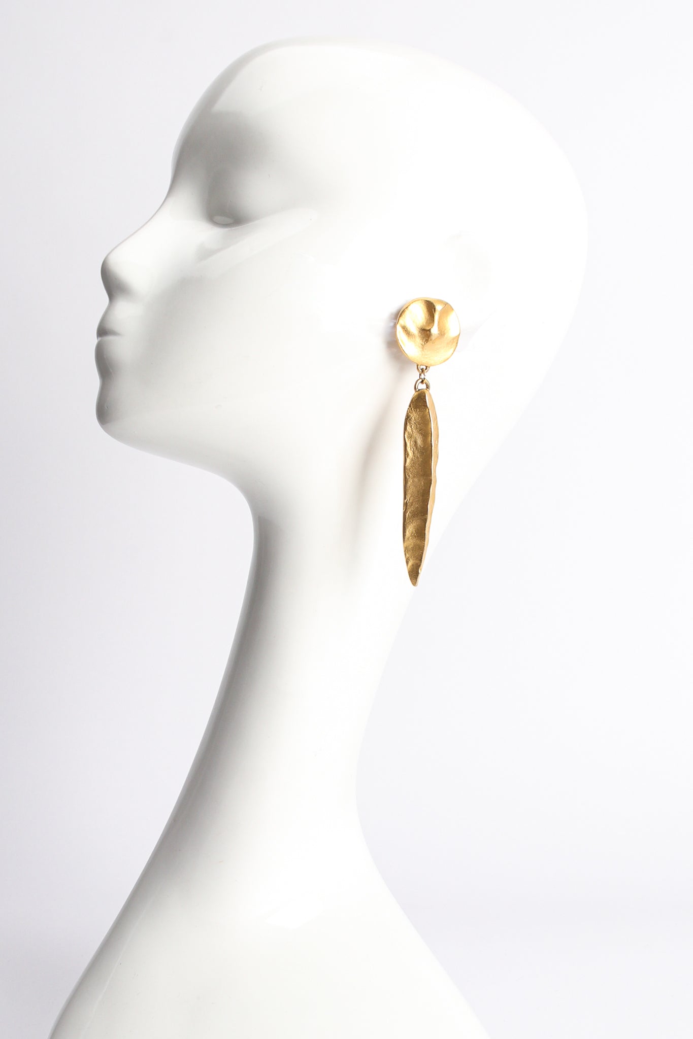 Vintage F. Mancini Matte Gold Sculpted Leaf Drop Earrings on mannequin at Recess Los Angeles