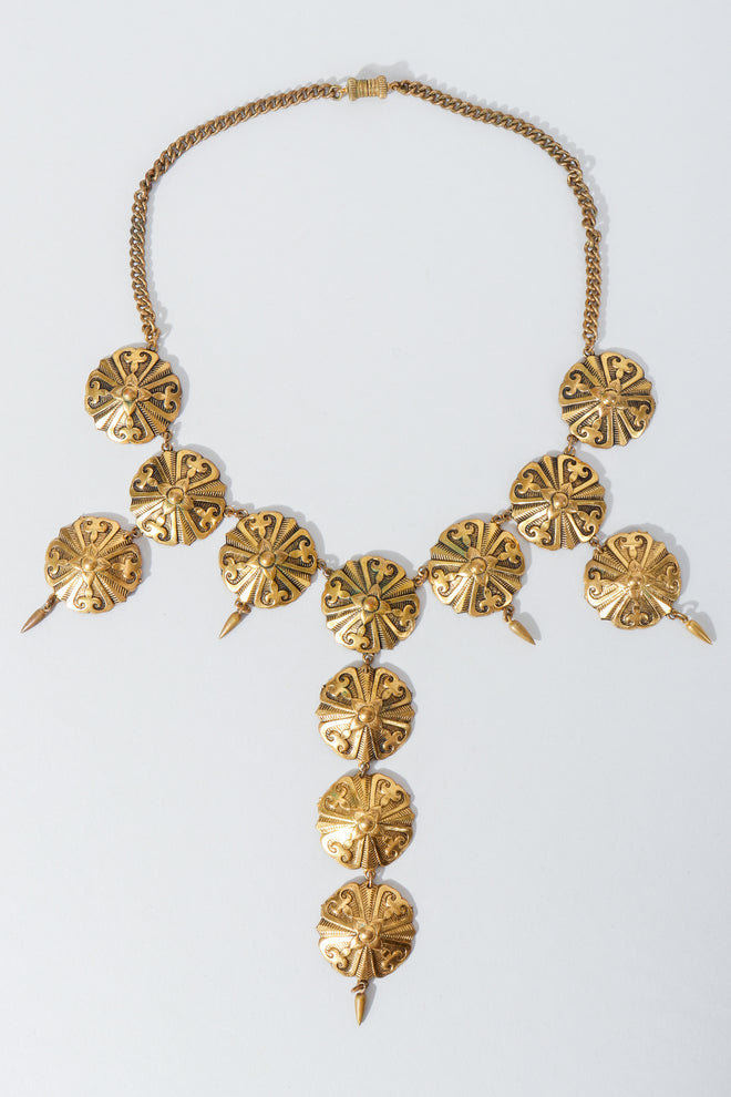 Vintage Unsigned Gothic Disc Brass Bib Y Necklace on grey at Recess los angeles