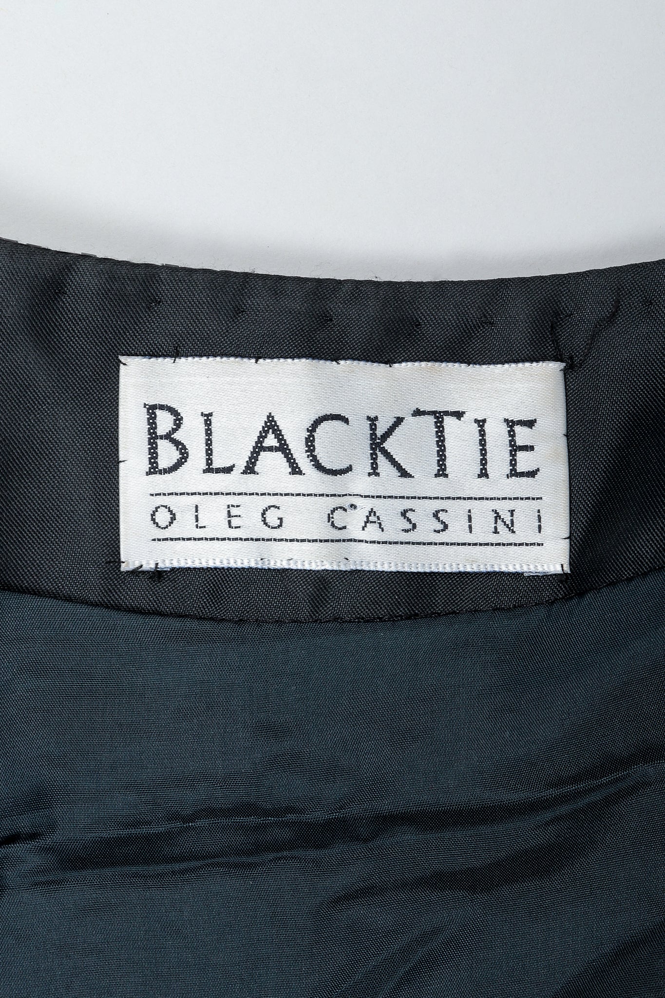 Vintage Oleg Cassini Black Tie Label on black fabric