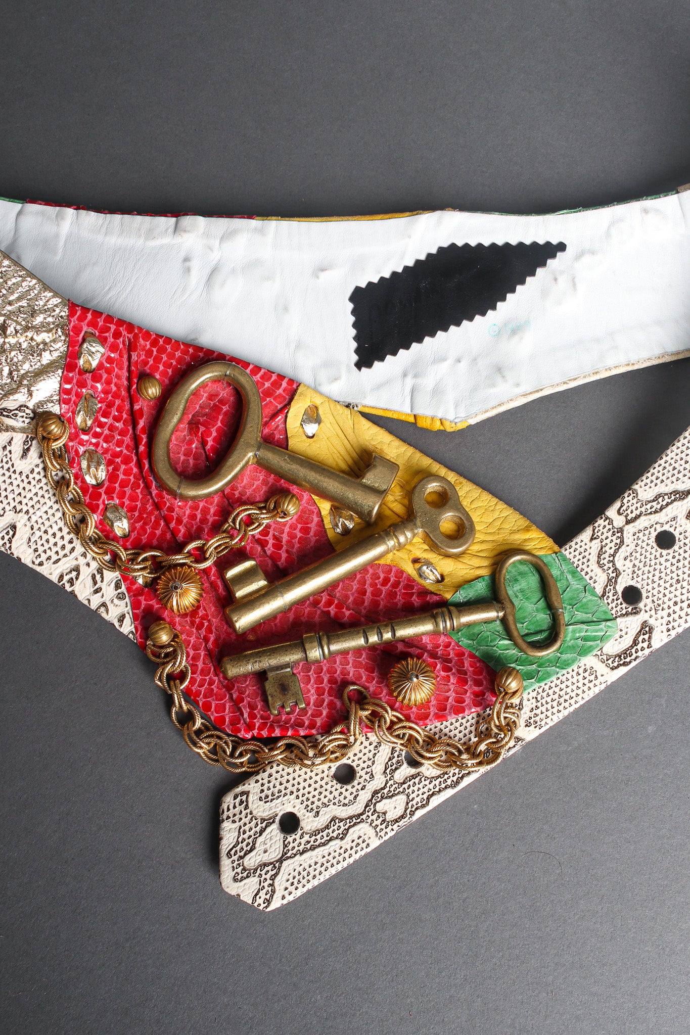 leather belt with with gold keys by Paula K flat lay @recessla
