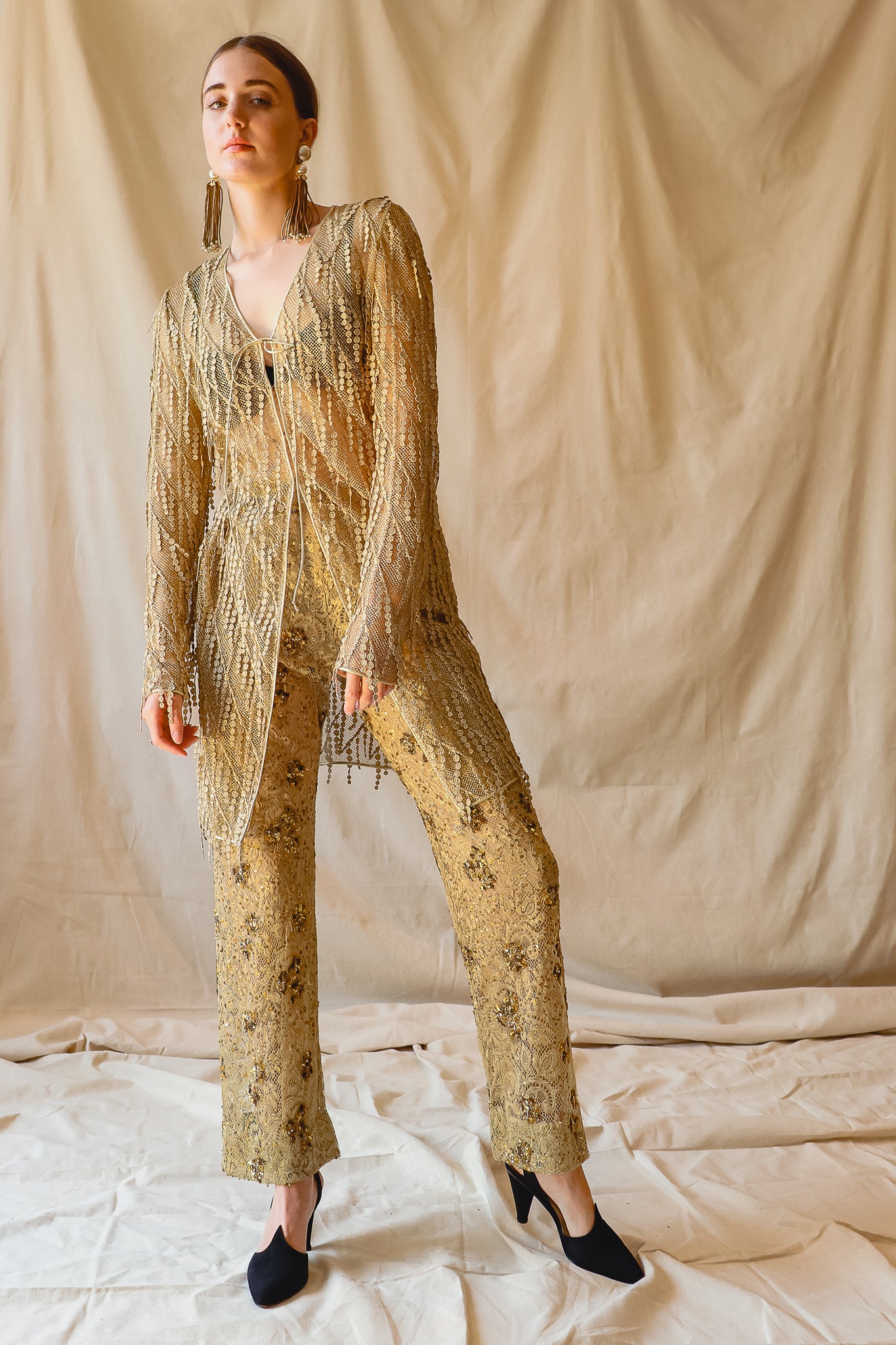 Girl in Vintage Badgley Mischka Mesh Fringe Jacket Gold Sequin Pant Set at Recess LA