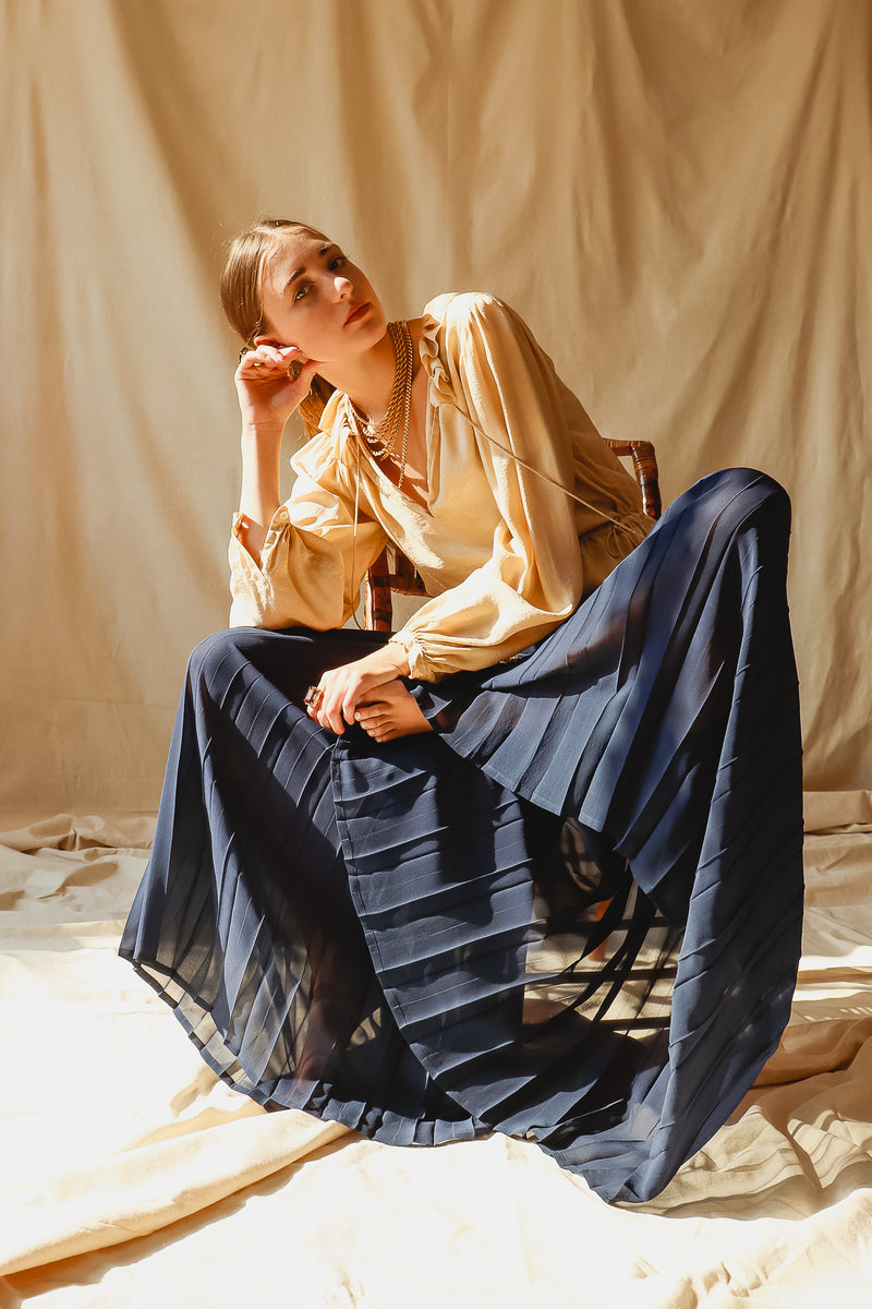 Girl in Vintage Mila Schon Sheer Chiffon Palazzo Pant at Recess Los Angeles sitting on chair