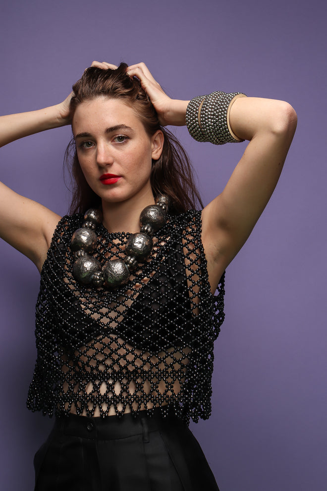 girl in Vintage 60s Bead Mesh Boxy Top & bra on purple background at Recess Los Angeles