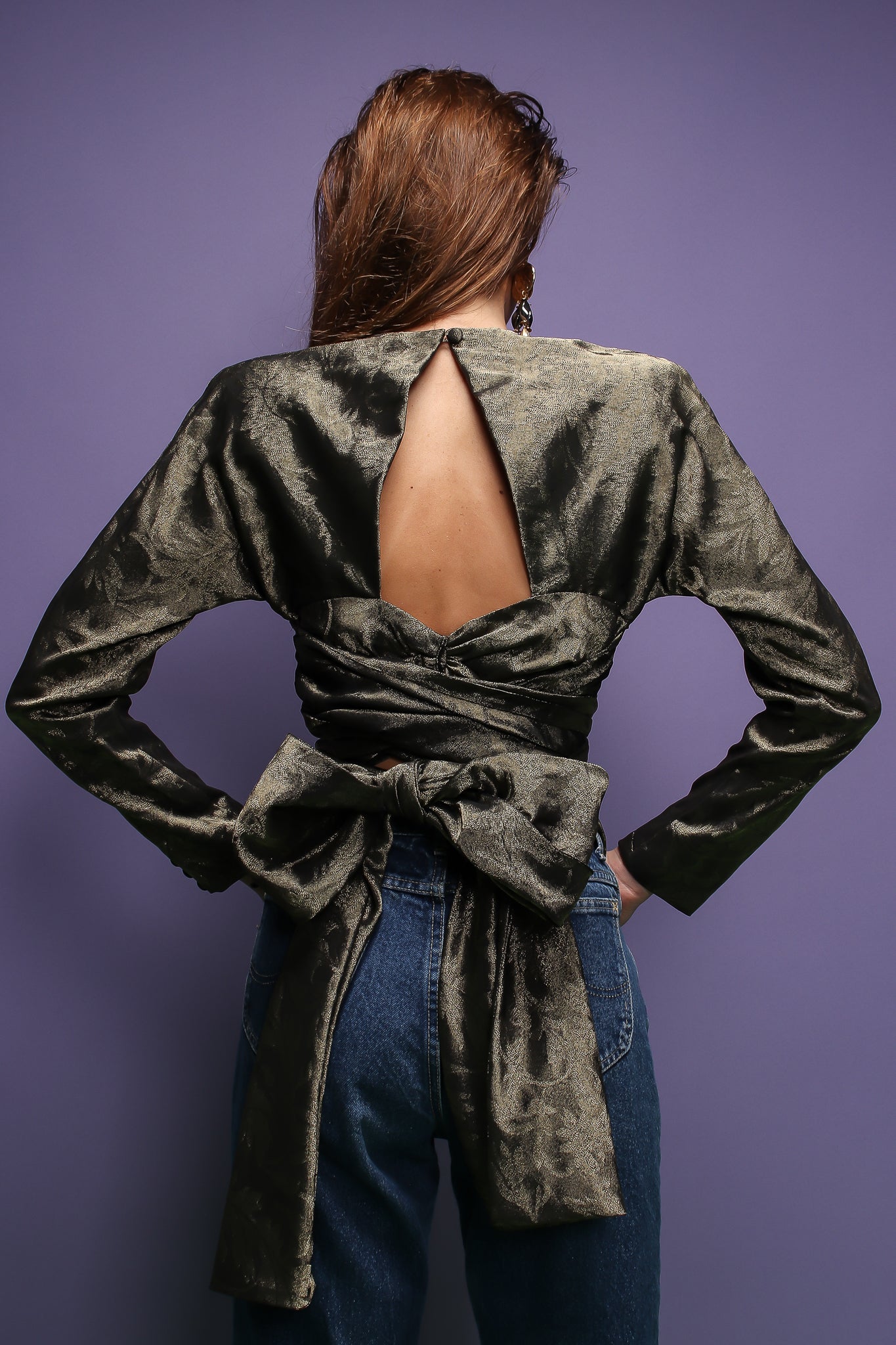 girl in Vintage Carolyne Roehm Metallic Backless Waist Wrap Top on purple background at Recess LA