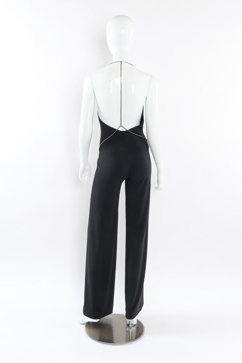 Black lycra backless halter jumpsuit with y-chain belt detail by Plein Sud back mannequin view @recessla