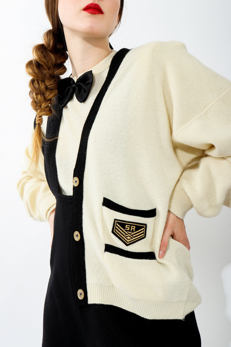 Girl wearing Vintage Sonia Rykiel Cream Knit Letterman Cardigan with bow tie sweater