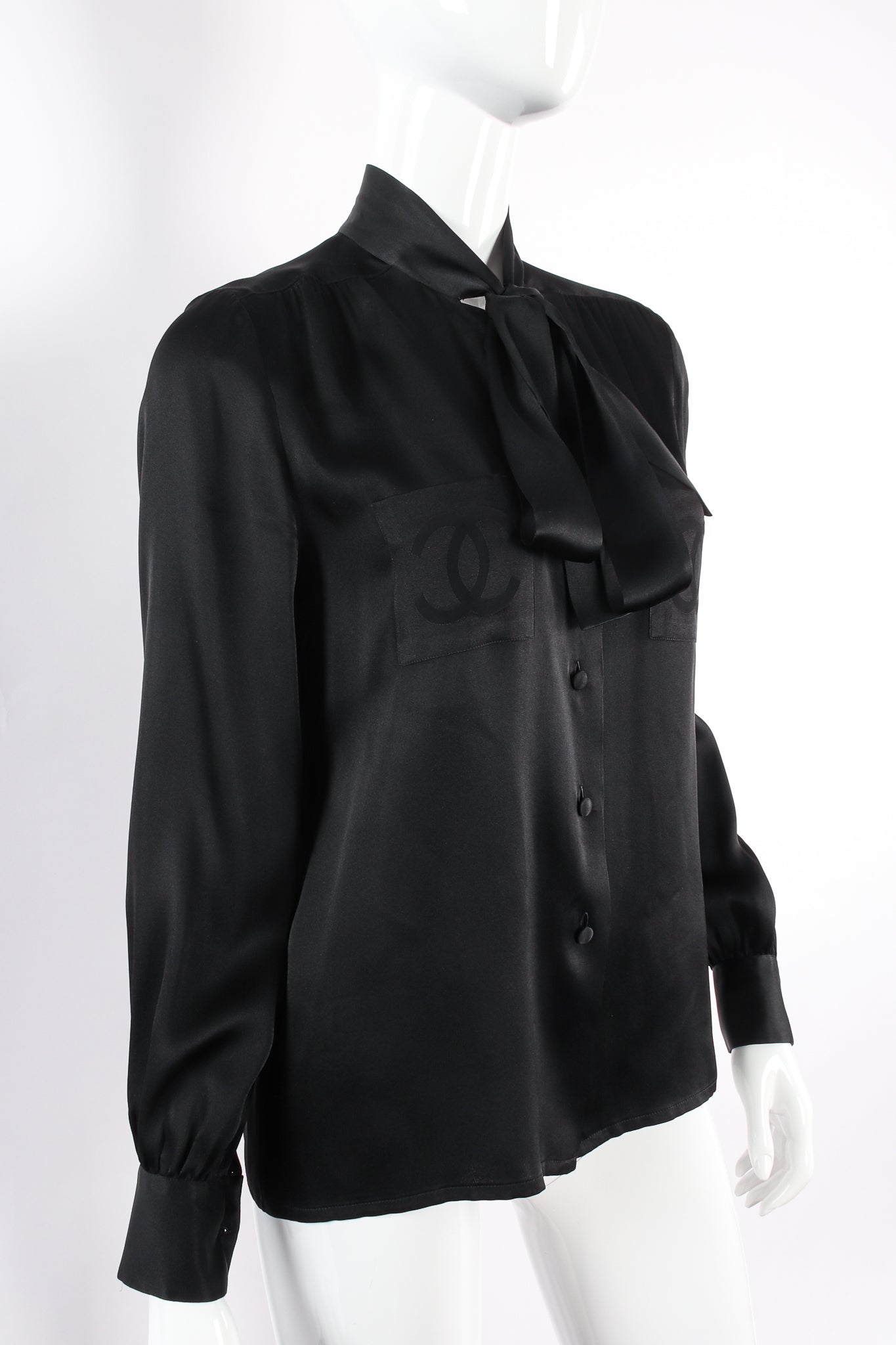 Vintage Chanel CC Pocket Black Silk Tie Neck Blouse on mannequin angle at Recess Los Angeles